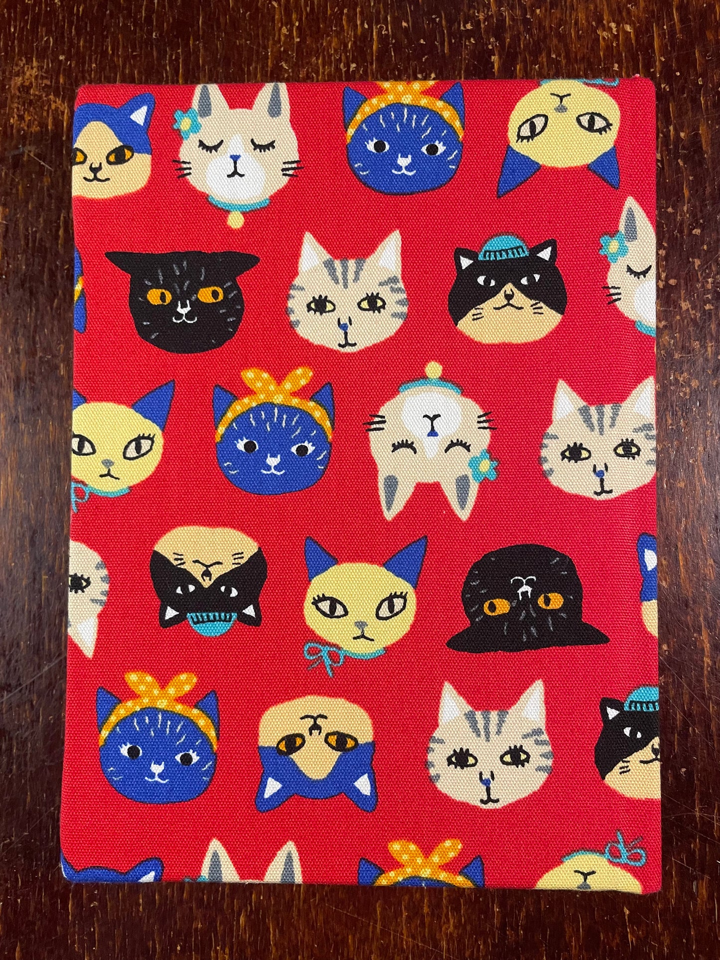 Sketchbook with cat illustrations on a red background