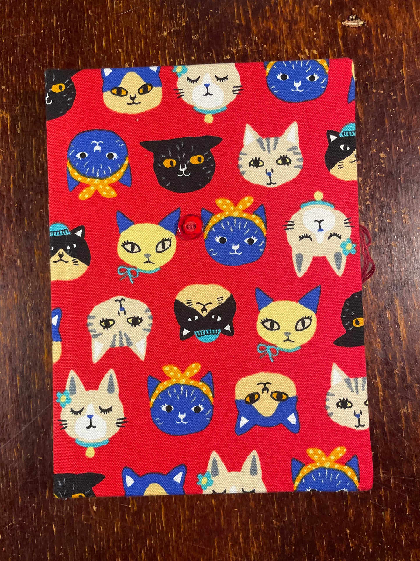 Notebook with cat pattern on a red background