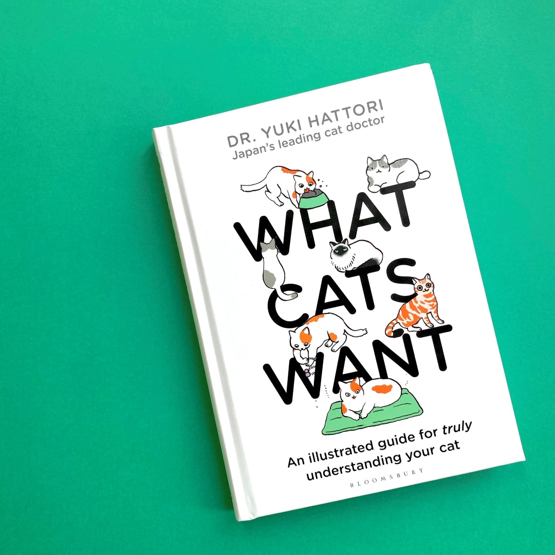 Book titled 'What Cats Want' by Dr. Yuki Hattori on a green background